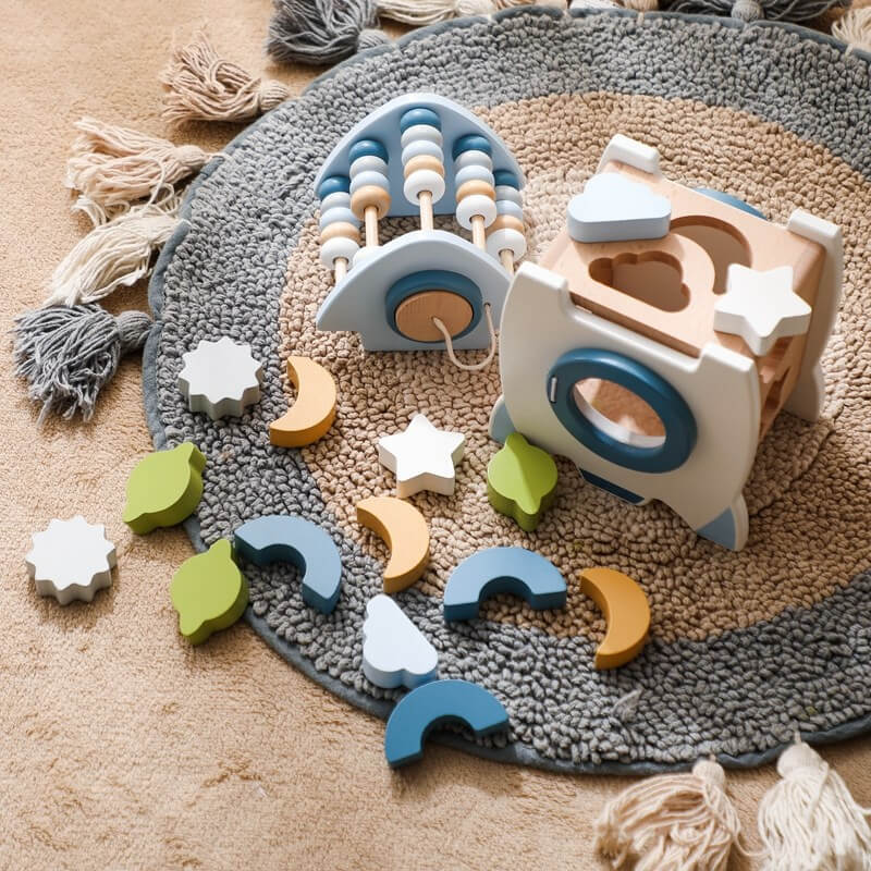 A wooden rocket toy with a shape pairing, a bottom door that opens to take out the input shape block, and a wheel for more fun. Great for cultivating hand-eye coordination. Montessori Learning Educational Gift idea Birthday Christmas Quality Wood Organic Wooden Toys Toddler Baby Board Games Puzzle