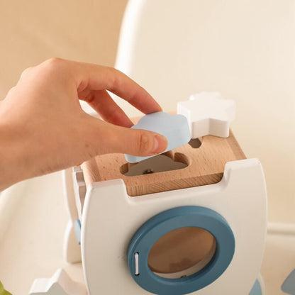 A wooden rocket toy with a shape pairing, a bottom door that opens to take out the input shape block, and a wheel for more fun. Great for cultivating hand-eye coordination. Montessori Learning Educational Gift idea Birthday Christmas Quality Wood Organic Wooden Toys Toddler Baby Board Games Puzzle